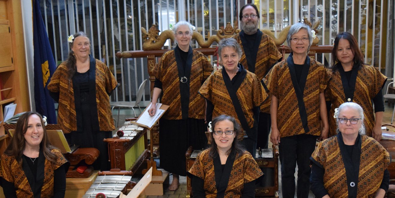 Gamelan Sari Pandhawa standing in uniform in front of the instruments